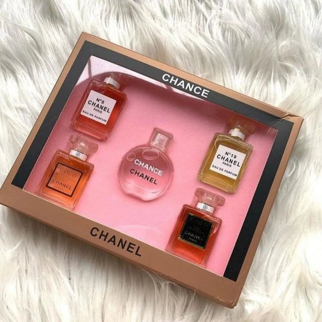 Chanel perfume set with five mini bottles in a box on a fluffy white surface