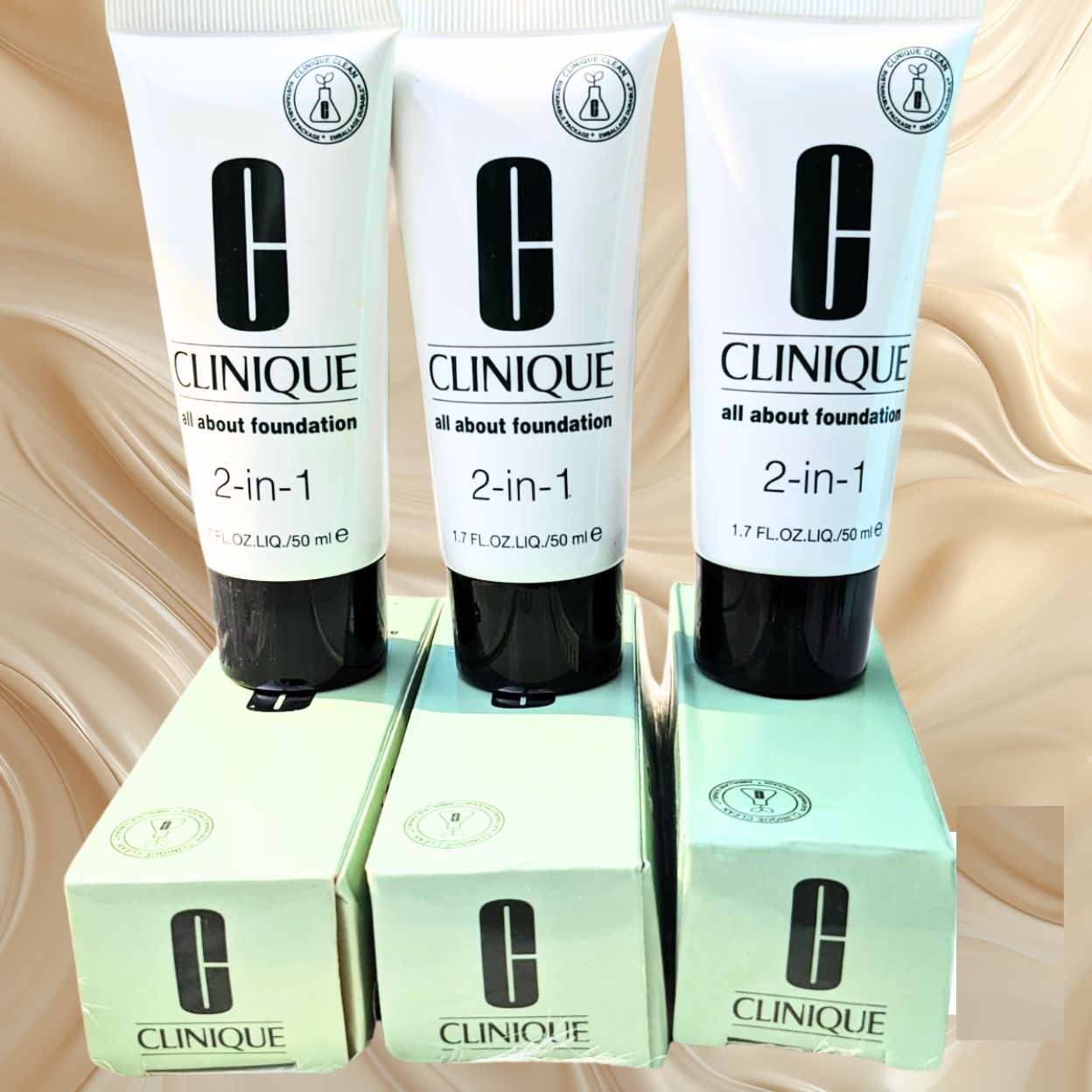 Three Clinique 2-in-1 foundation tubes with their boxes on a beige background at Maqbool store