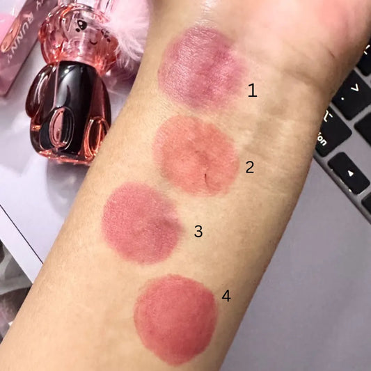 Lipstick swatches on a person's arm with a blurred background