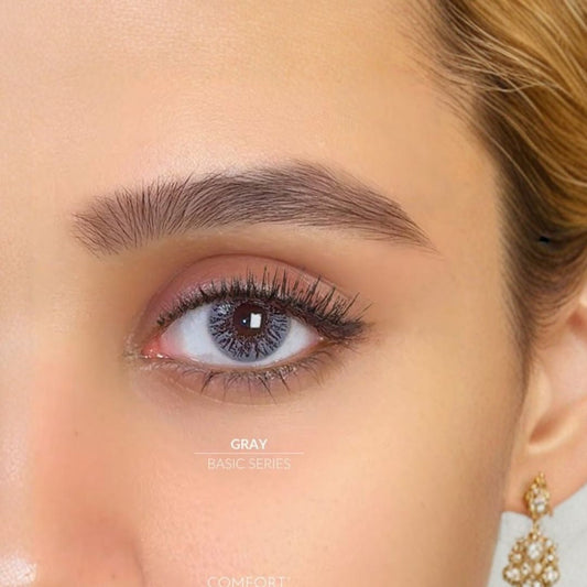 Close-up of a woman's eye with gray contact lenses, wearing an earring at best price online sale in Pakistan
