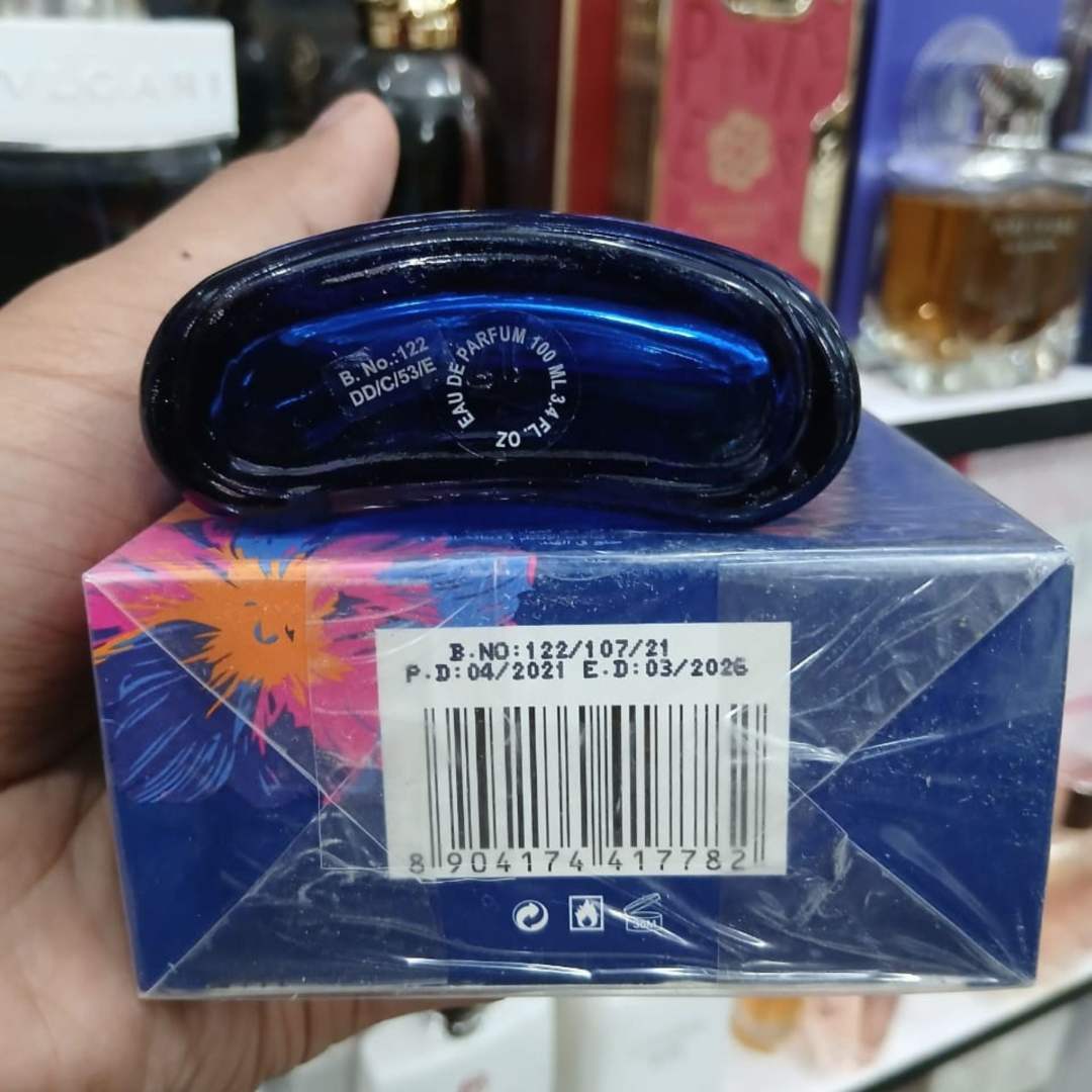 Blue perfume bottle with brand logo and text.