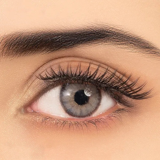 Close-up of an eye wearing gray contact lenses of ultimate plus