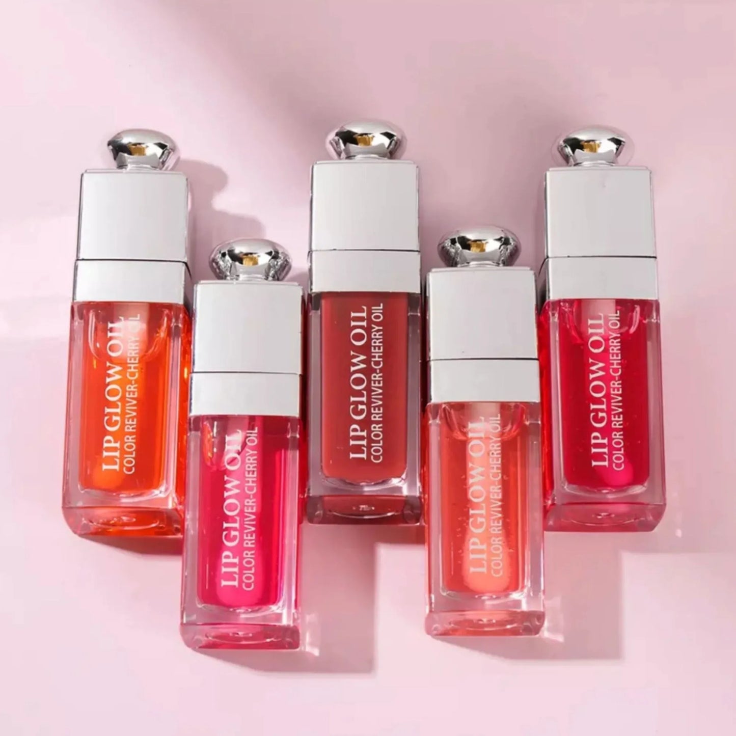 Set of Lip Glow Oil products on a pink background at best price online sale in Pakistan