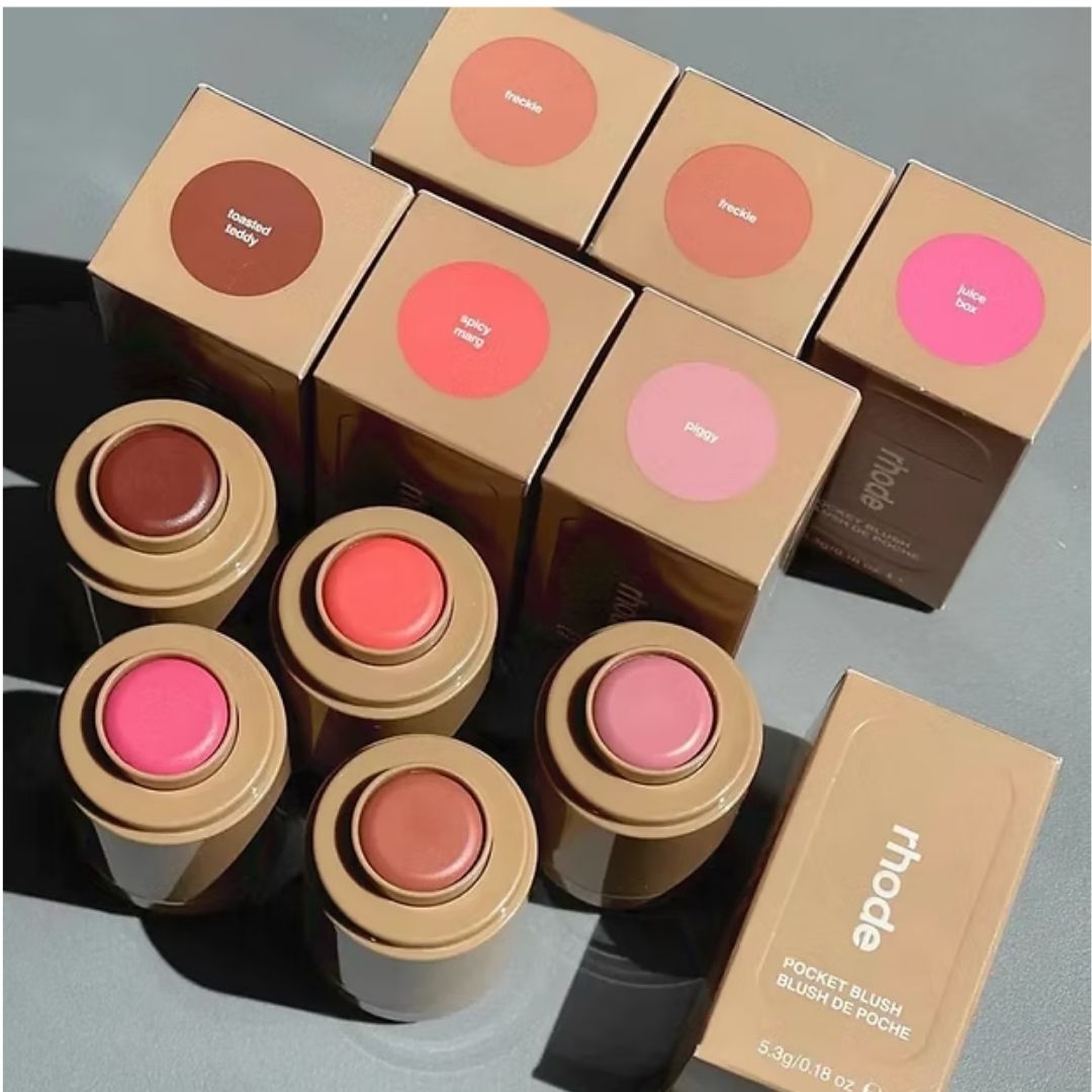 Collection of Rhode makeup products including blushes and boxes on a gray background at best price online sale in Pakistan