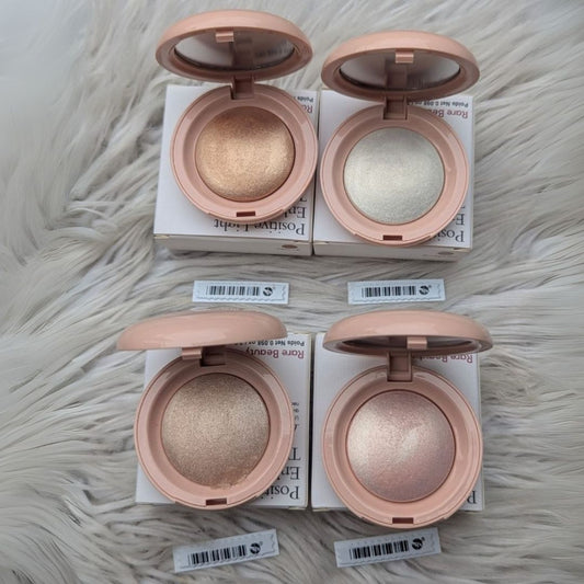 Four open makeup compact cases with different shades on a textured surface at best price online sale in Pakistan