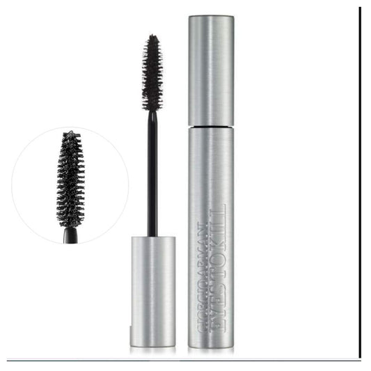 Mascara with silver tube and black brush on a white background