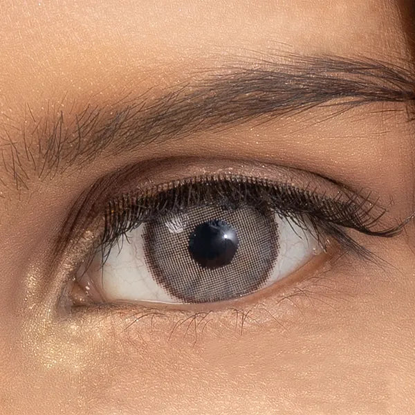 Close-up of a person's eye with brown ULTIMATE PLUS CONTACT LENSES 