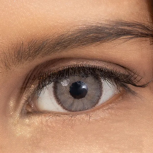 Close-up of a person's eye with brown ULTIMATE PLUS CONTACT LENSES 