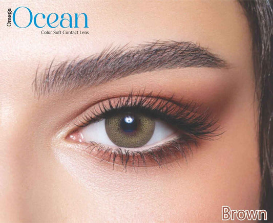 Close-up of a brown eye with contact lenses, featuring Omega Ocean branding.