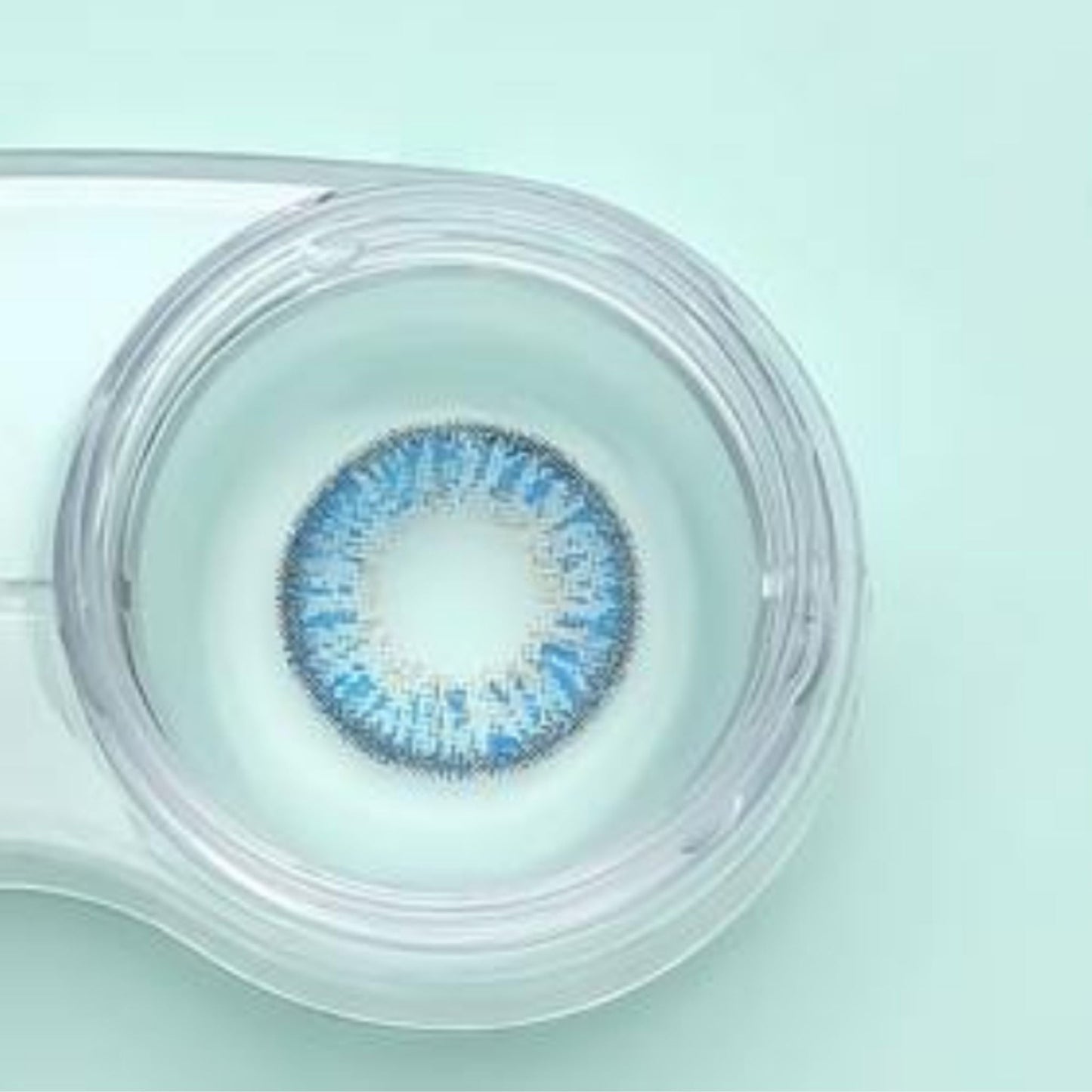 Comfort rainbow aqua Blue contact lens in a clear case on a light green background at maqbool store 