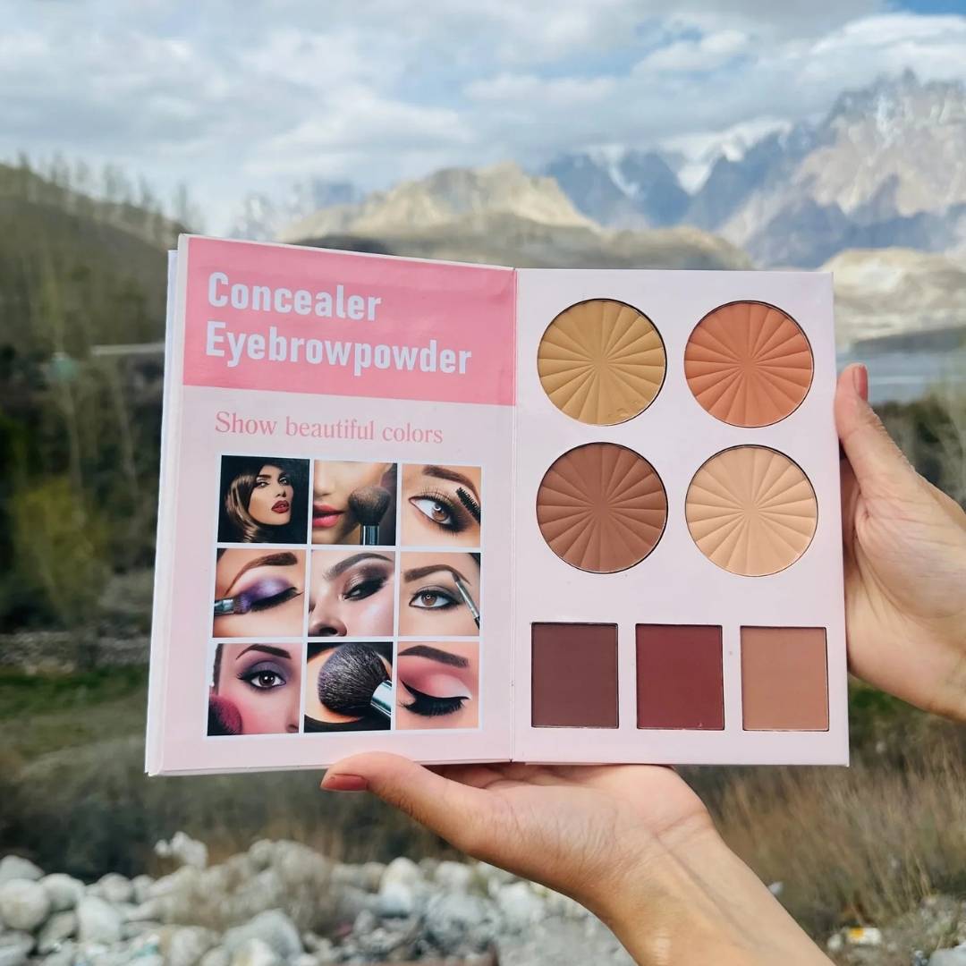Makeup palette with concealer, eyebrow powder, and blush shades held against a mountainous landscape.