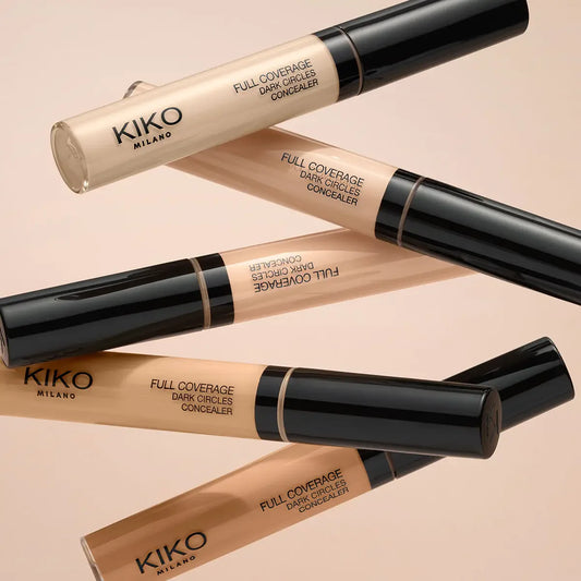 Kiko Milano full coverage dark circles concealers on a beige background