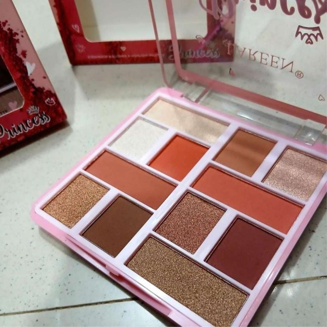 Makeup palette with various shades of eyeshadows on a light surface, with a brand name visible.