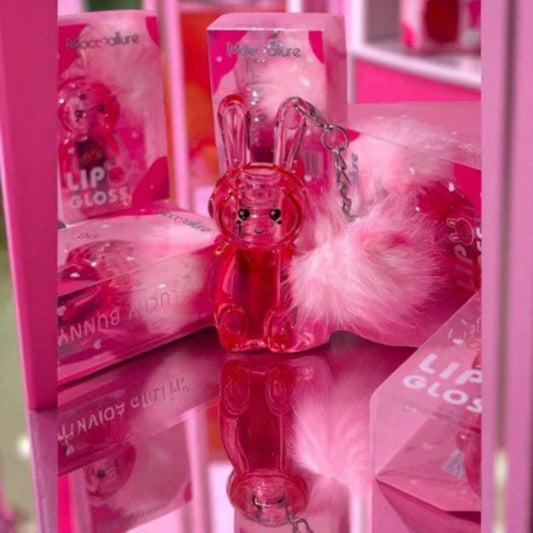 Pink lip gloss with bunny design and fluffy keychain in packaging