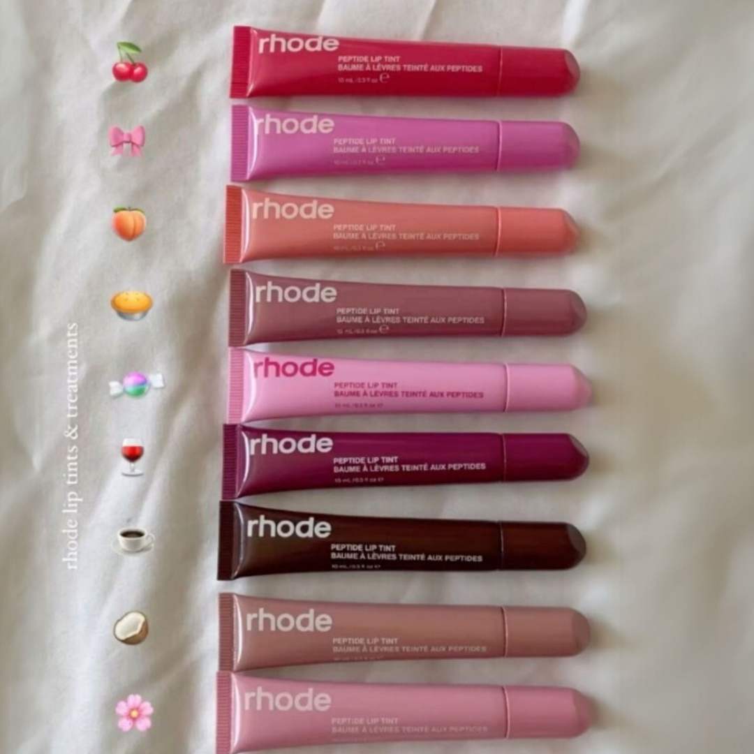 Row of Rhode lip tint tubes on a textured white background