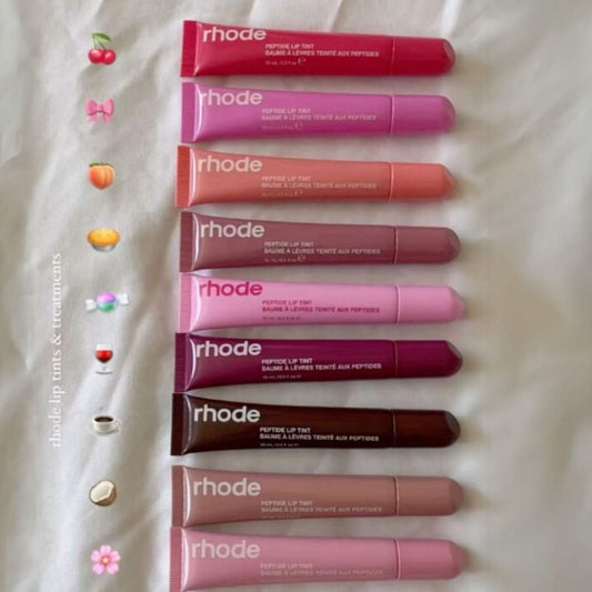Row of Rhode lip tint tubes on a textured white background