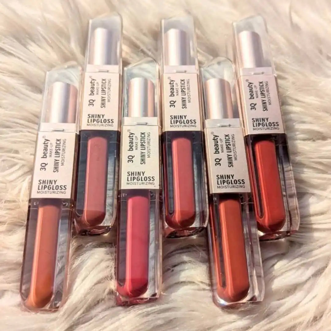 Set of 6 lip glosses on sale in red shades on a textured surface