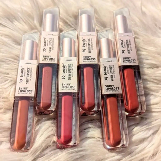 Set of 6 lip glosses on sale in red shades on a textured surface
