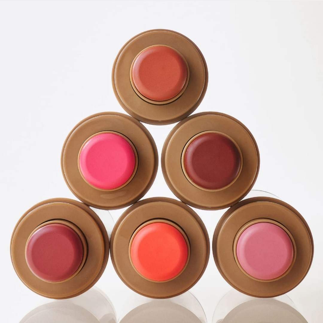 Set of six rhore blush on containers with different colored blush on on a white background