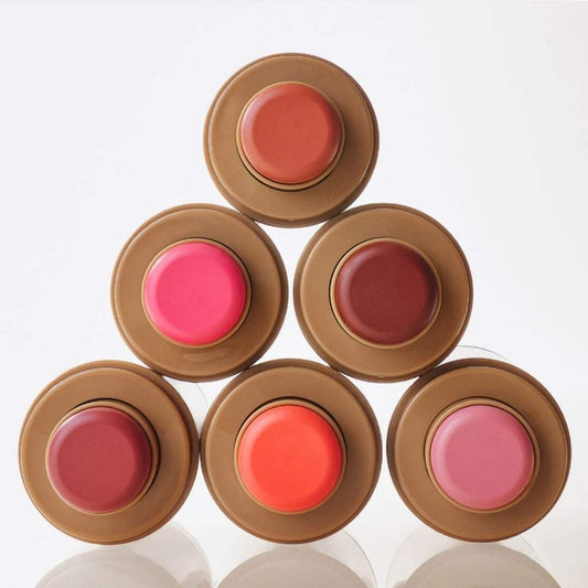 Set of six rhore blush on containers with different colored blush on on a white background