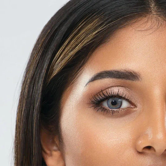 Close-up of an eye wearing blue contact lenses of ultimate plus