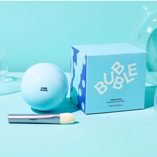 bubble_clay_mask ball with packaging and brush on a light blue background