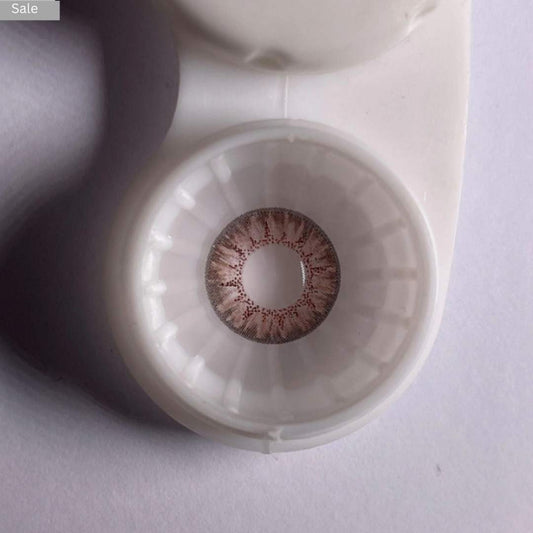 Brown comfort contact pretty_lens brown_color in a white case on a light background