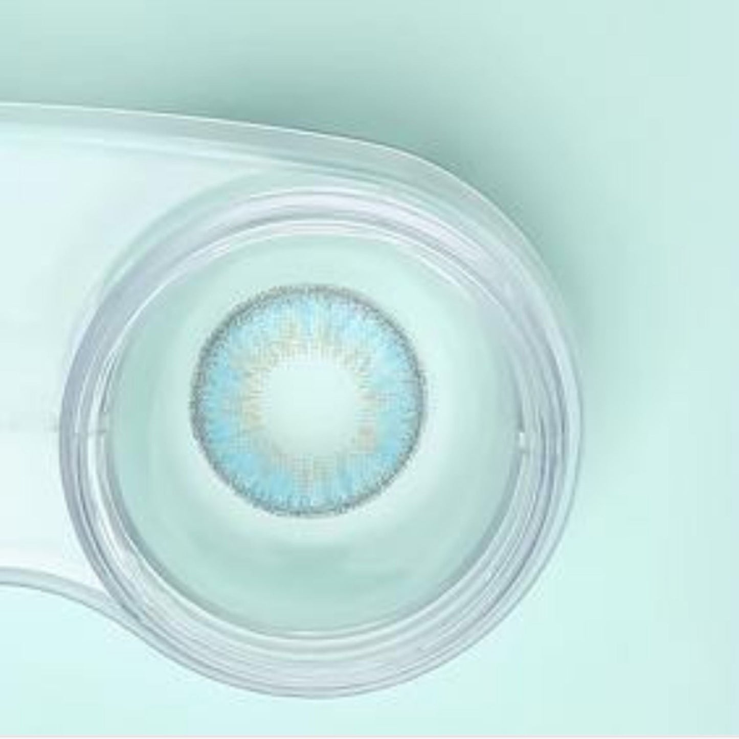 comfort rainbow contact lenses sky blue in a clear case on a light green background