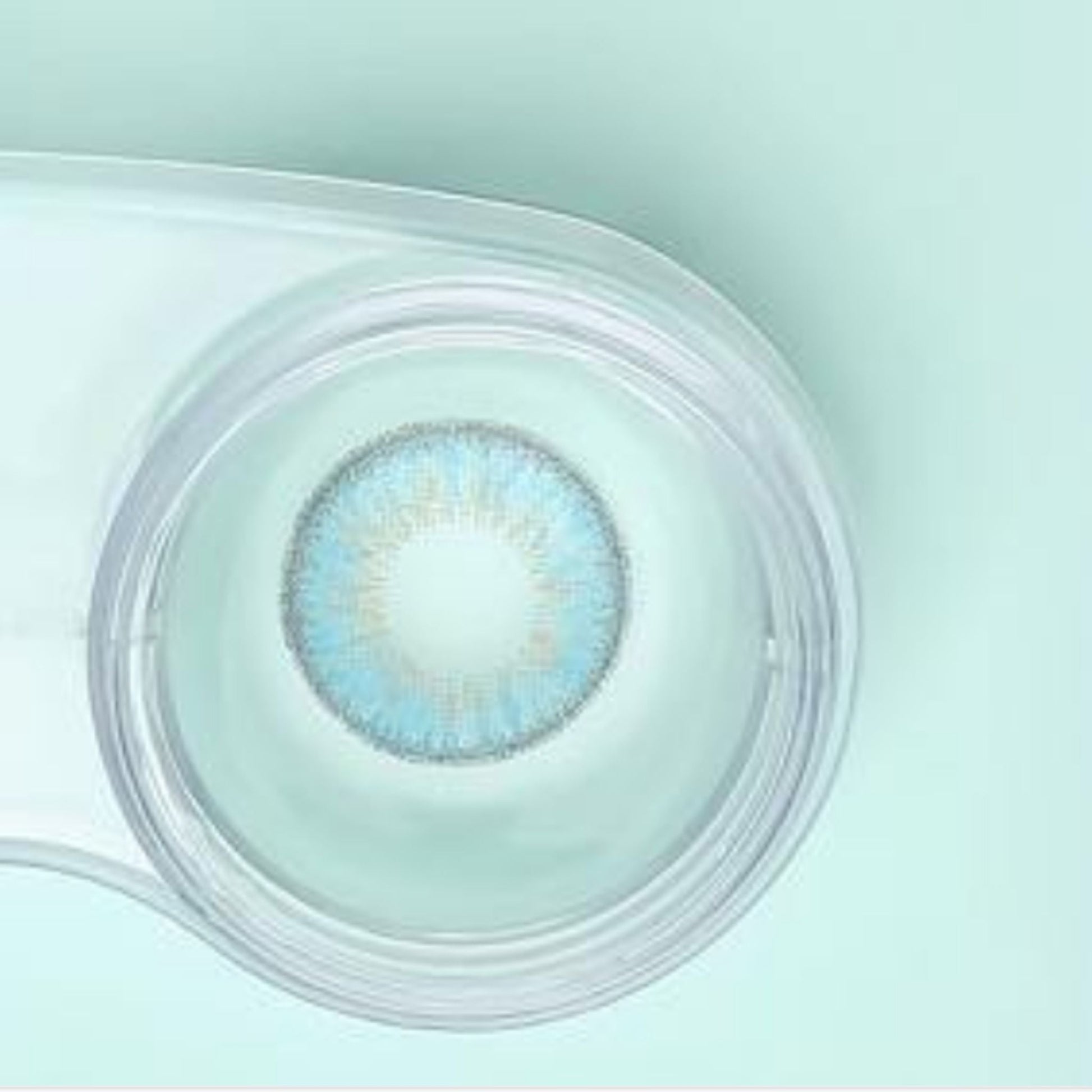 comfort rainbow contact lenses sky blue in a clear case on a light green background