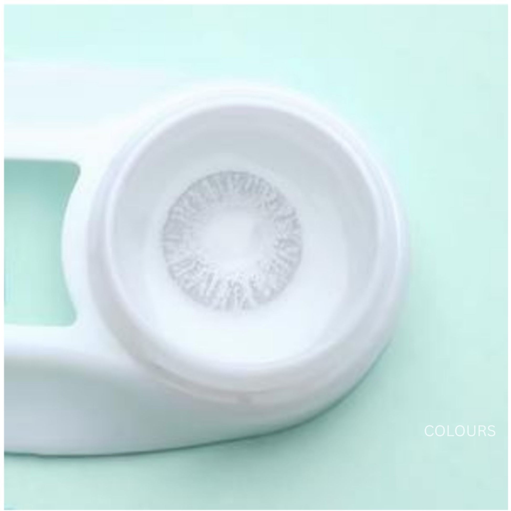Close-up of a contact lens with a white case on a light green background at best price online sale in Pakistan