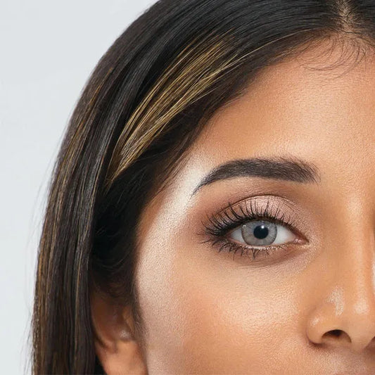 Close-up of an eye wearing gray contact lenses of ultimate plus