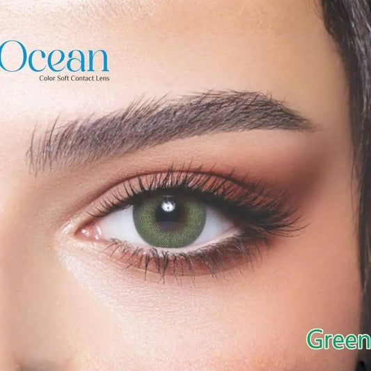 Close-up of a safe green contact lens worn by a person, with 'Ocean' branding.