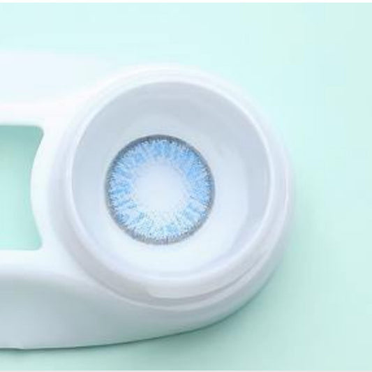 Blue contact lens in a white case on a light green background at best price online sale in Pakistan