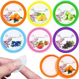 Set of colorful fruit-themed nail polish remover containers with a hand holding one at best price online sale in Pakistan