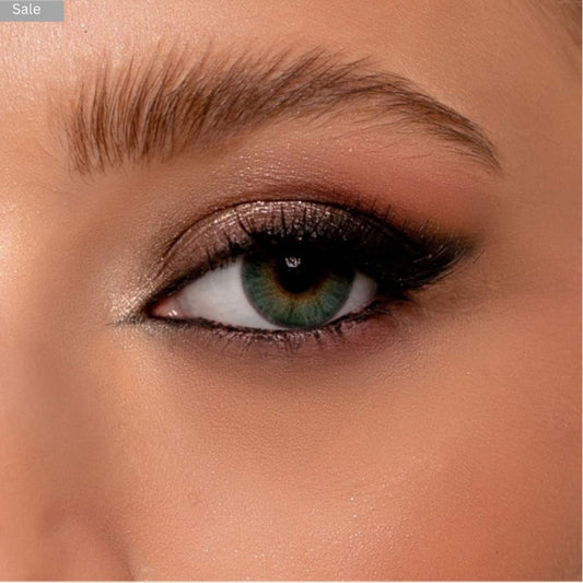 Close-up of a person's eye with makeup, including pretty green lens, eyeliner and eyeshadow.