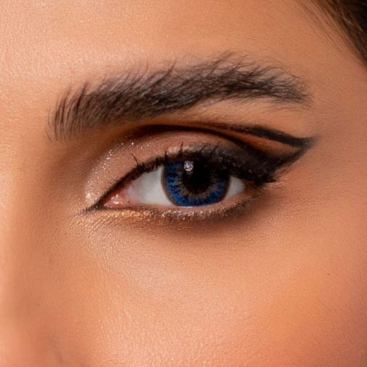 Close-up of a person's eye with rainbow aqua blue contact lenses