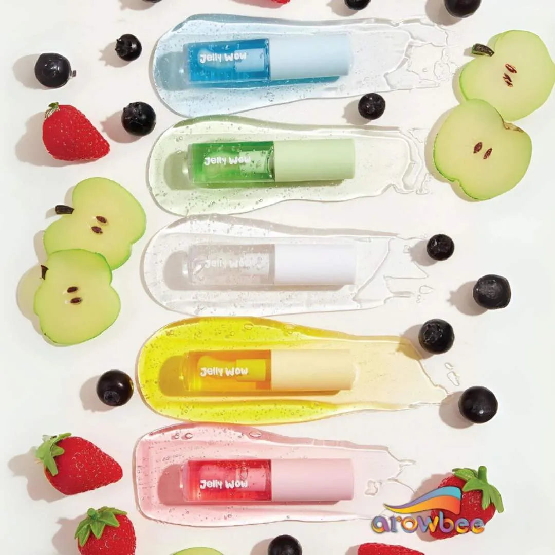 Set of colorful sheglam lip oil with fruit-themed packaging on a white background