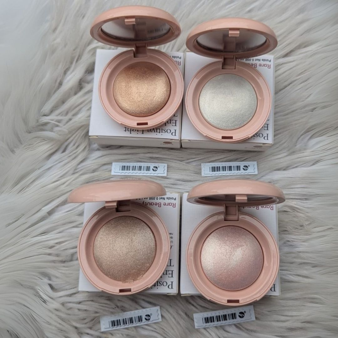 Four open makeup compact cases with different shades on a textured surface at best price online sale in Pakistan