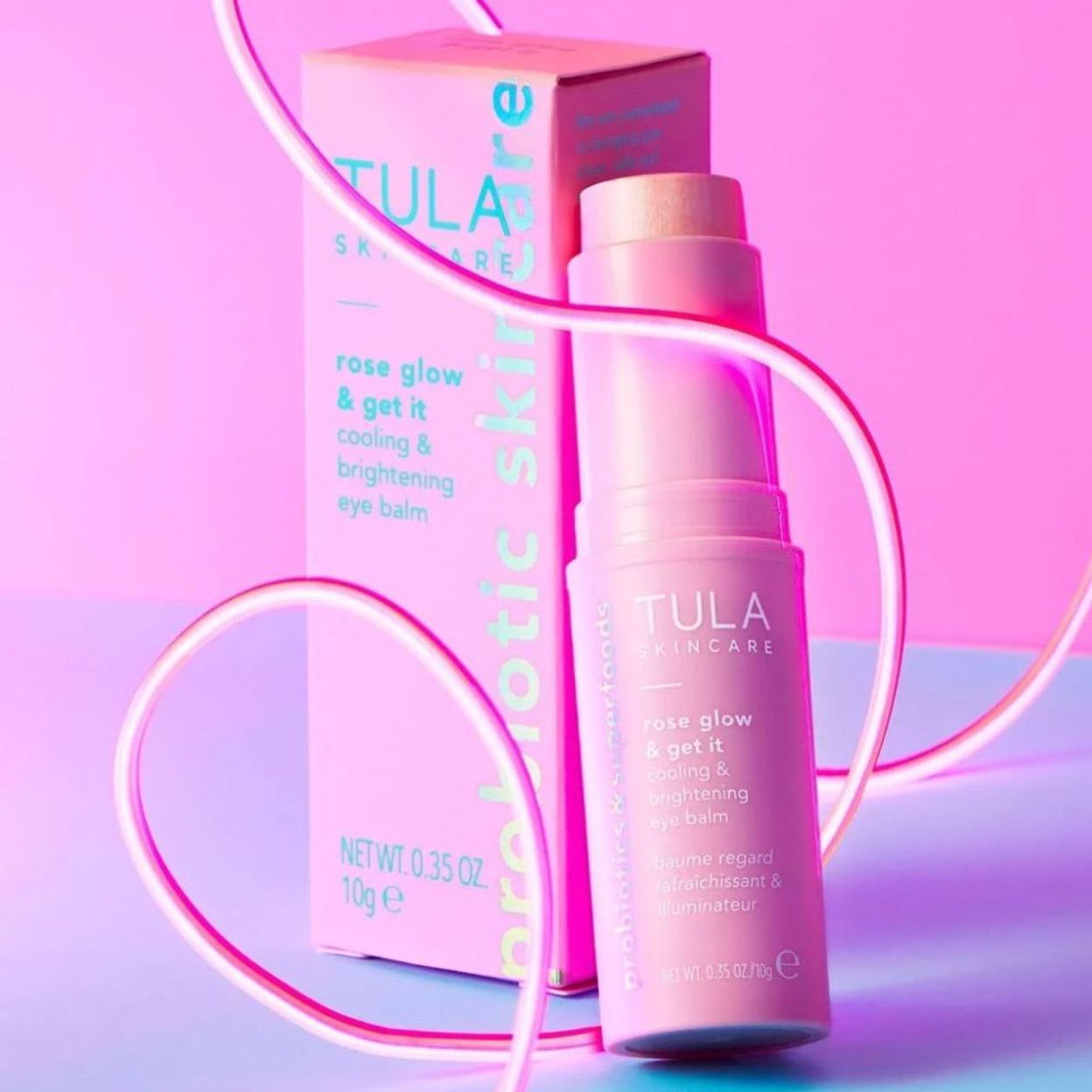 Tula skincare product with packaging on a pink and purple gradient background