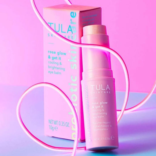 Tula skincare product with packaging on a pink and purple gradient background