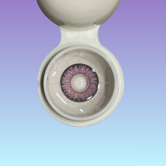 Close-up of a contact lens in a container with a gradient background